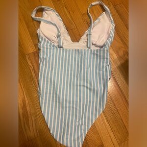 light blue and white striped one piece bathing suit.